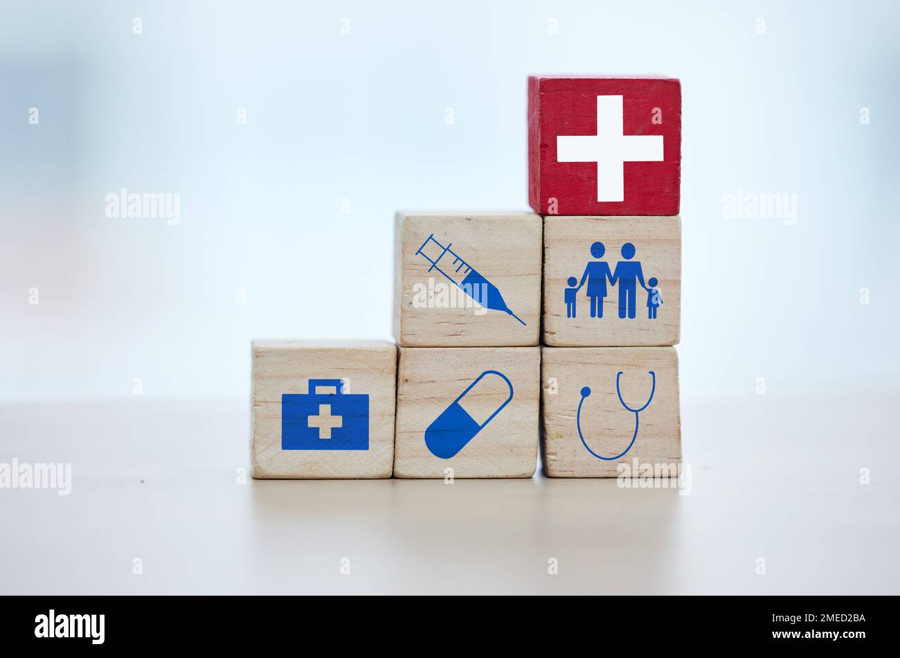 Healthcare, insurance and wooden blocks in studio on an empty gray background for safety or security. Abstract, medicine and health with block toys in Stock Photo