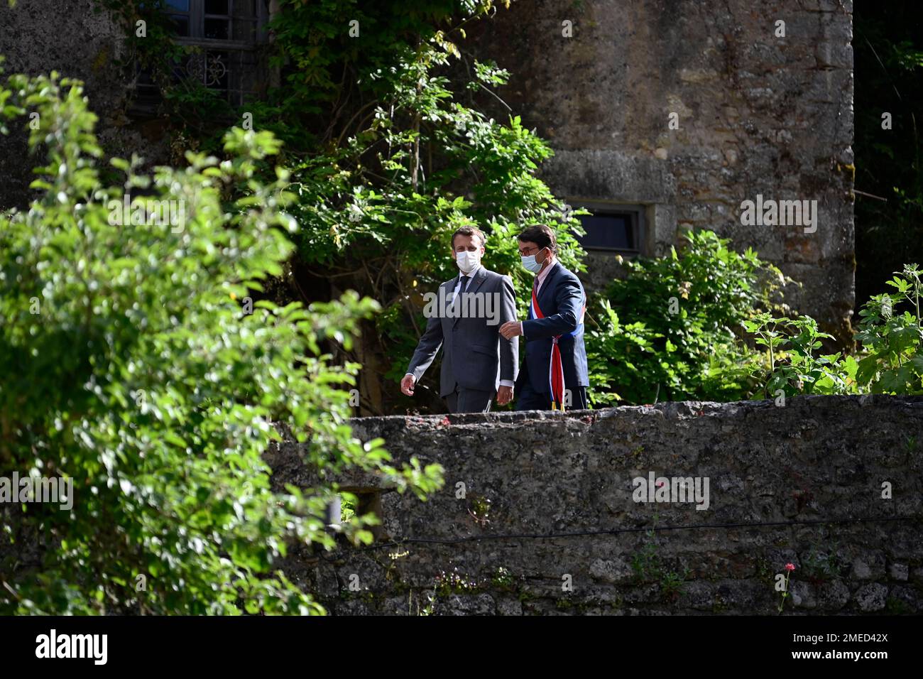 French President Emmanuel Macron, left, and French mayor Gerard Miquel  visit in Saint-Cirq-Lapopie, near Cahors, southwestern France, Wednesday,  June 2, 2021. Macron is on a two-day visit in the Lot region to