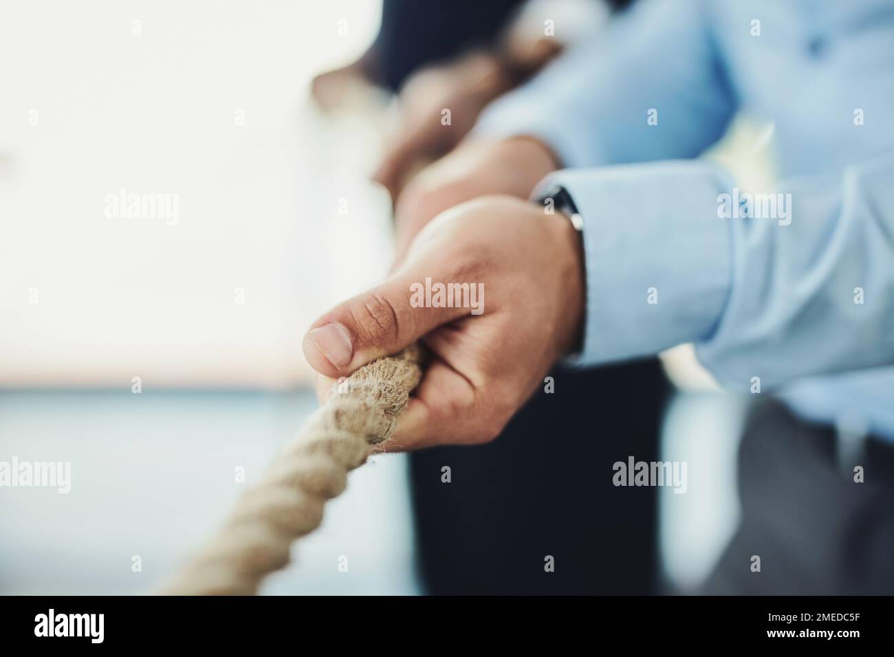 Person pulling rope, close-up stock photo