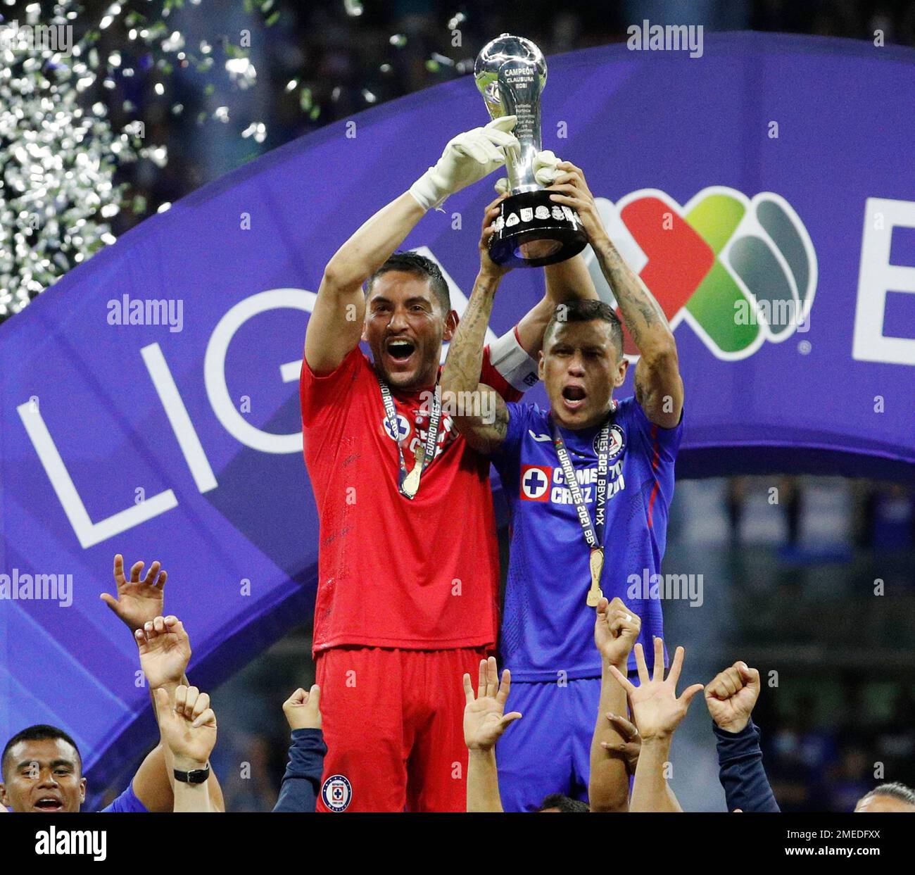 Cruz Azul's goalkeeper Jose Corona, left, and Julio Dominguez lift
