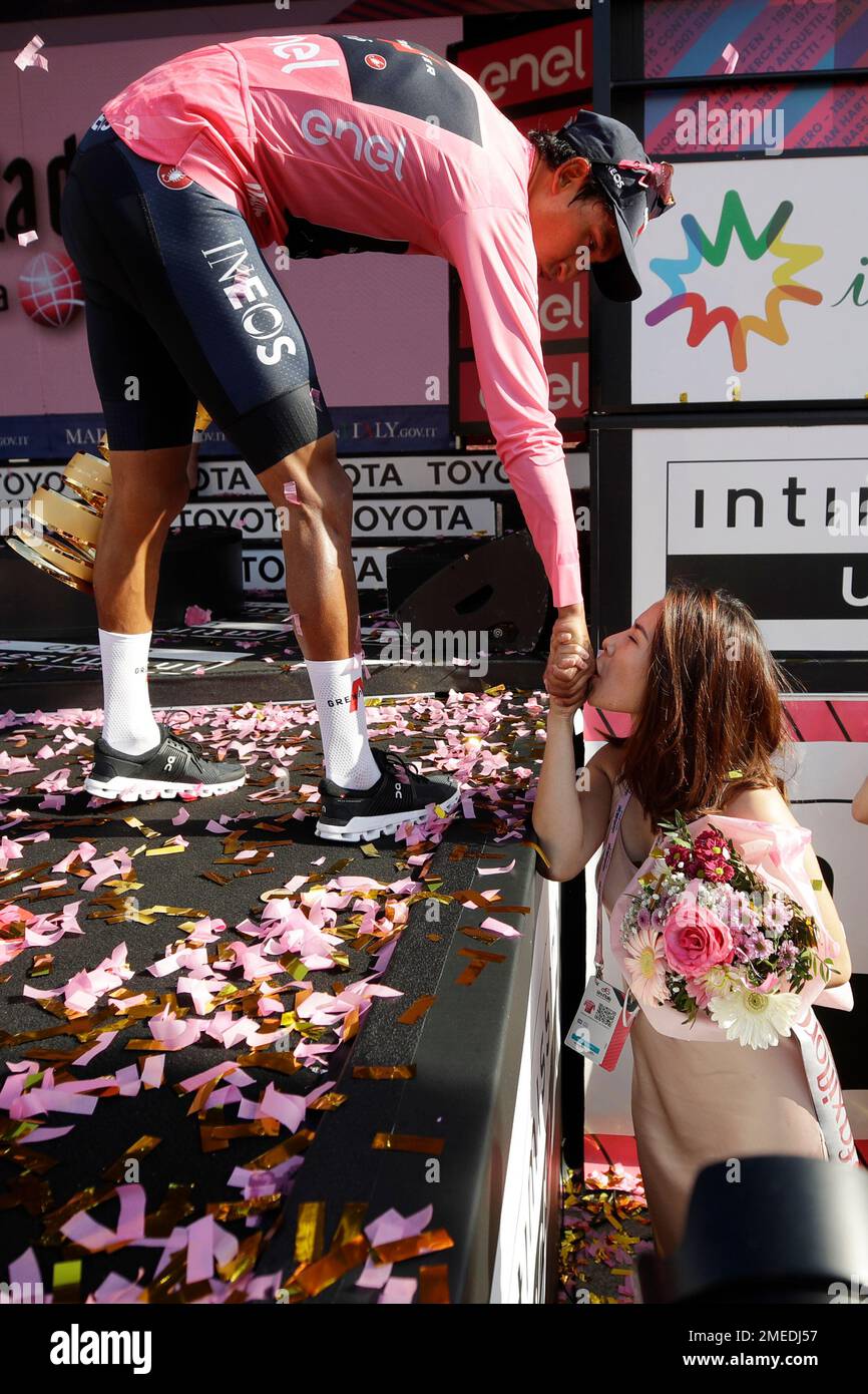 Colombia's Egan Bernal bows toward his girlfriend Maria Fernanda Gutierrez,  kissing his hand, as he celebrates on podium after completing the final  stage to win the Giro d'Italia cycling race, in Milan,