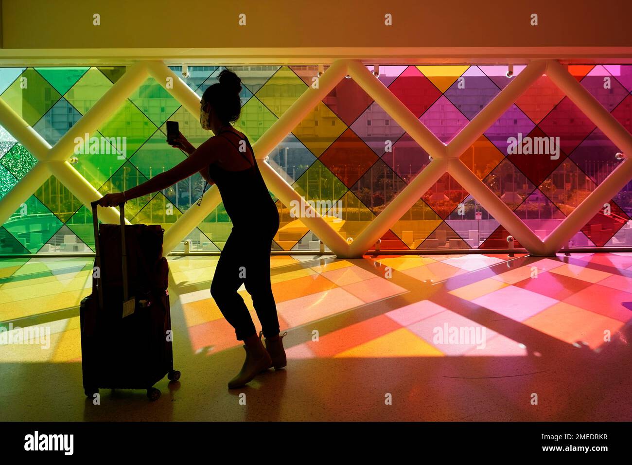 A traveller takes photos of windows titled harmonic convergence by