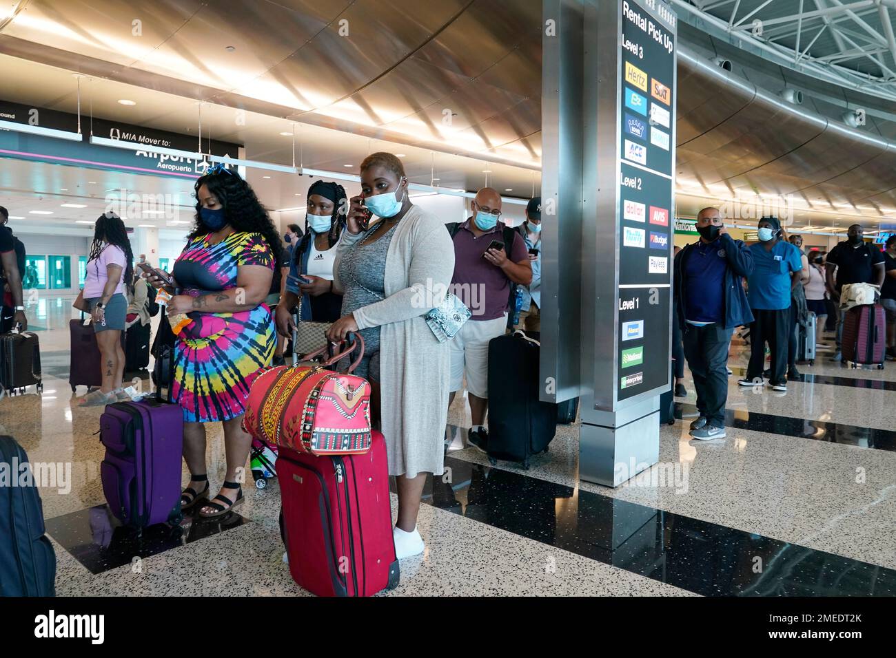 Gabbie Koomson of Texas, waits in a long line to rent a vehicle at