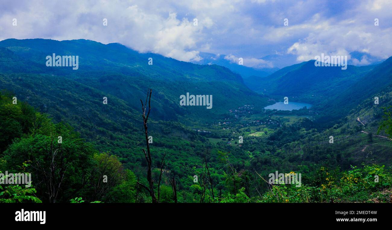 Panoramic View to the Blue Mountain Lake among the Green Forest Trees in the heart of Bosnia and Herzegovina Stock Photo