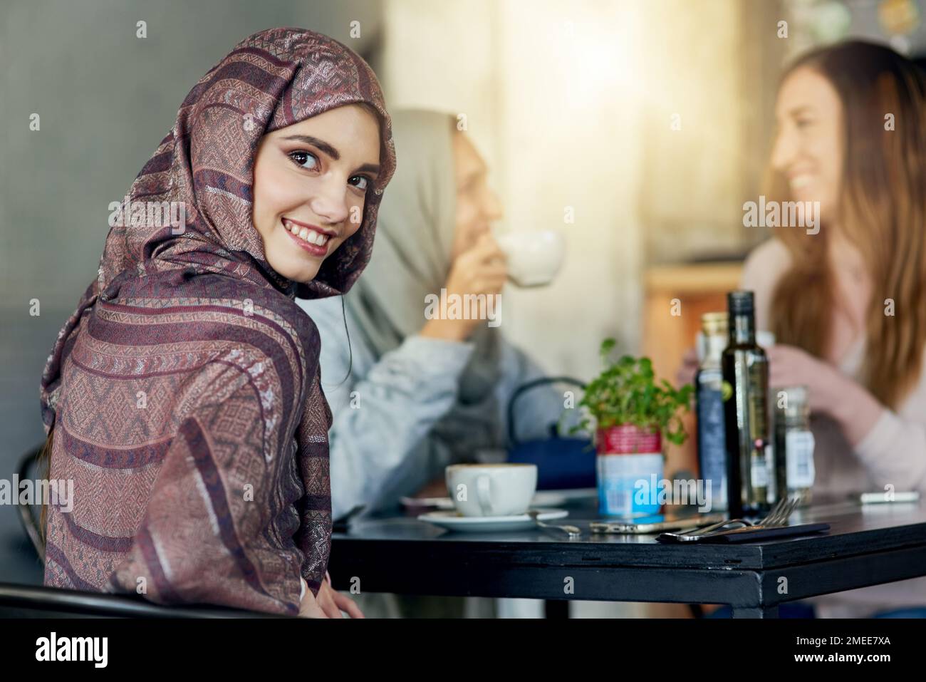 Anyone who loves coffee is a friend of mine. Portrait of a happy young woman spending time with her friends in a cafe. Stock Photo