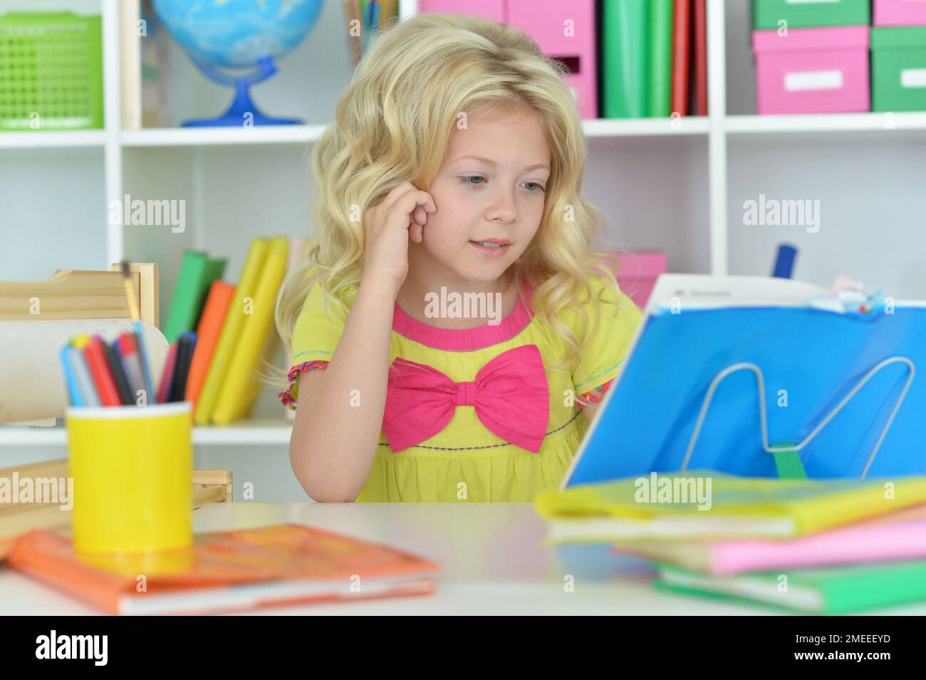little girl studying at home at the table Stock Photo - Alamy