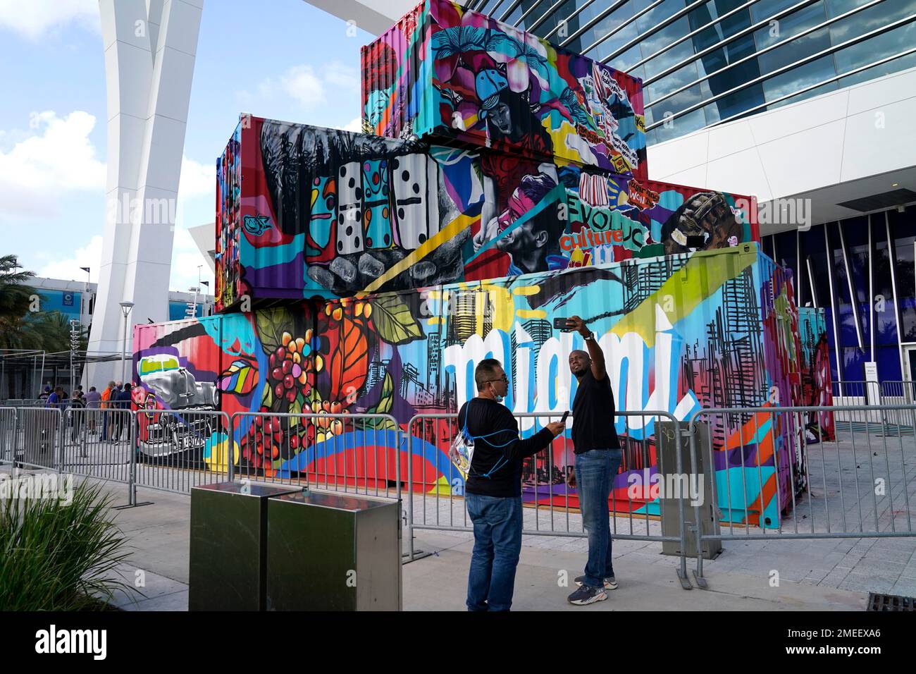 Fans take photographs next to a sculpture by Puerto Rican artist