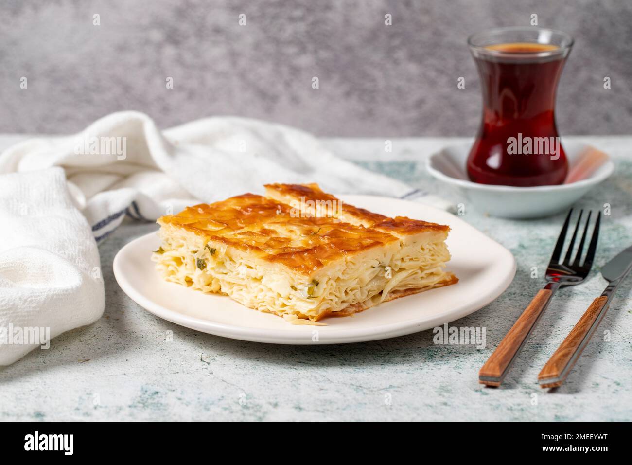 Turkish Su Boregi or Tabla borek with cheese. Turkish Patty on stone background. Close up Stock Photo