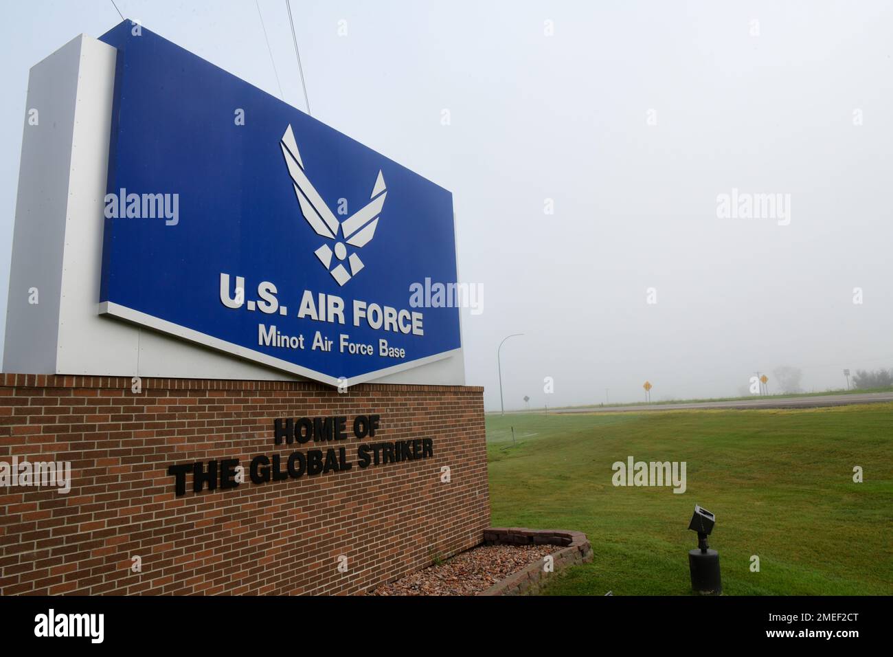 Heavy fog covers a sign at the front of the base entrance at Minot Air