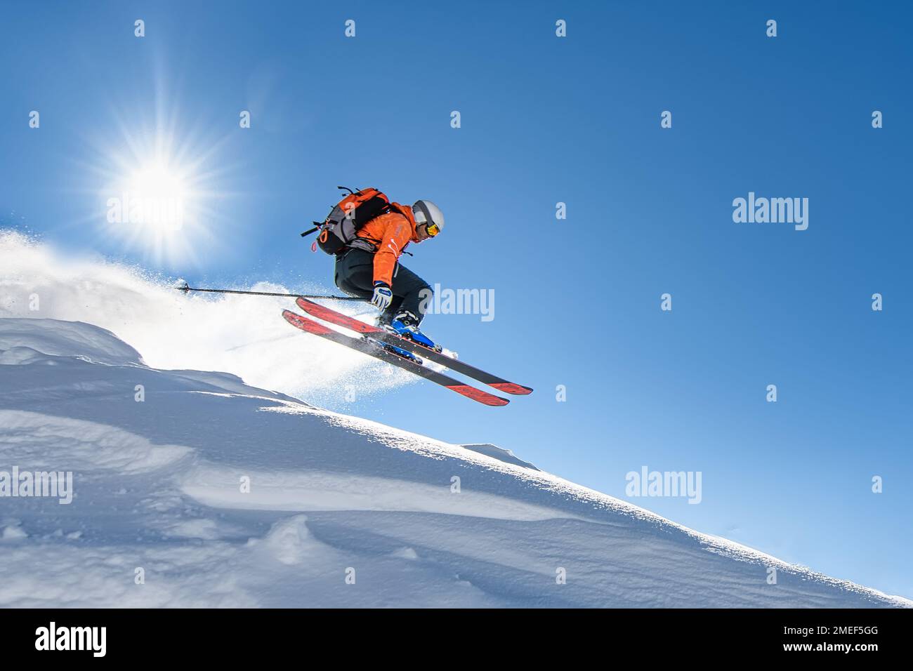 A young skier at speed flying through the sky Stock Photo