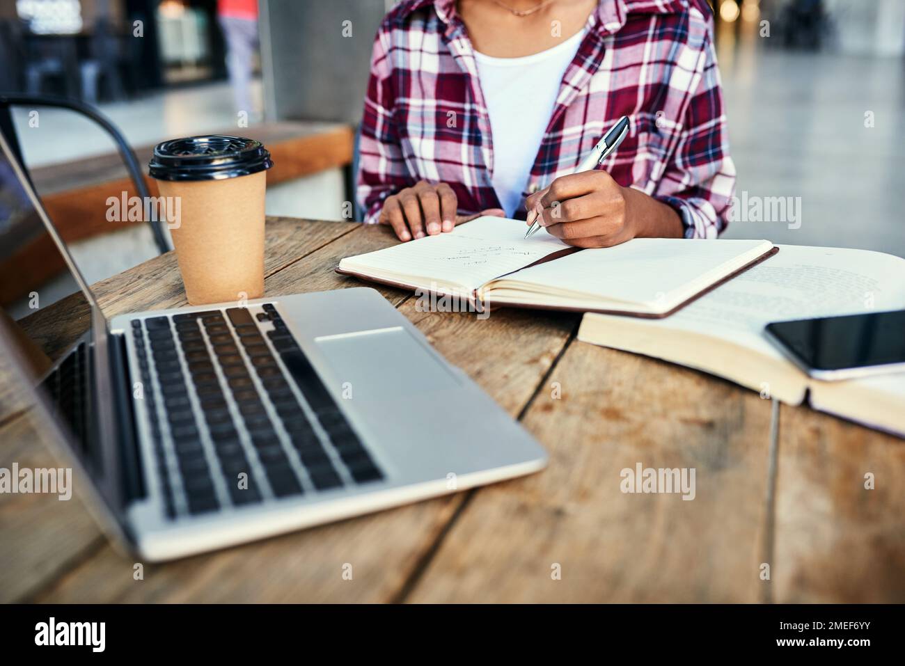 Jotting down notes for the paper. an unrecognizable female student