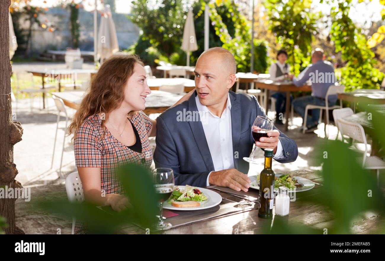 Adult couple having lunch at summer cafe terrace Stock Photo