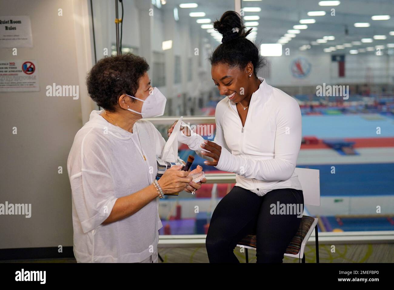 HOLD FOR MOVEMENT WITH STORY BY WILL GRAVES—Nellie Biles, left, helps(04)