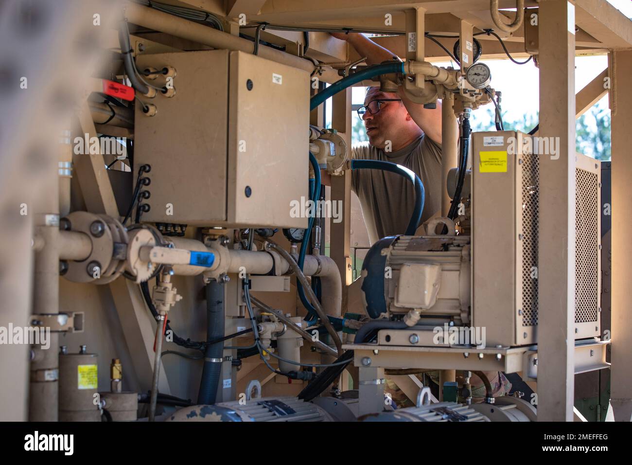Staff Sgt. Abdiel Colon, a water treatment specialist, works on the