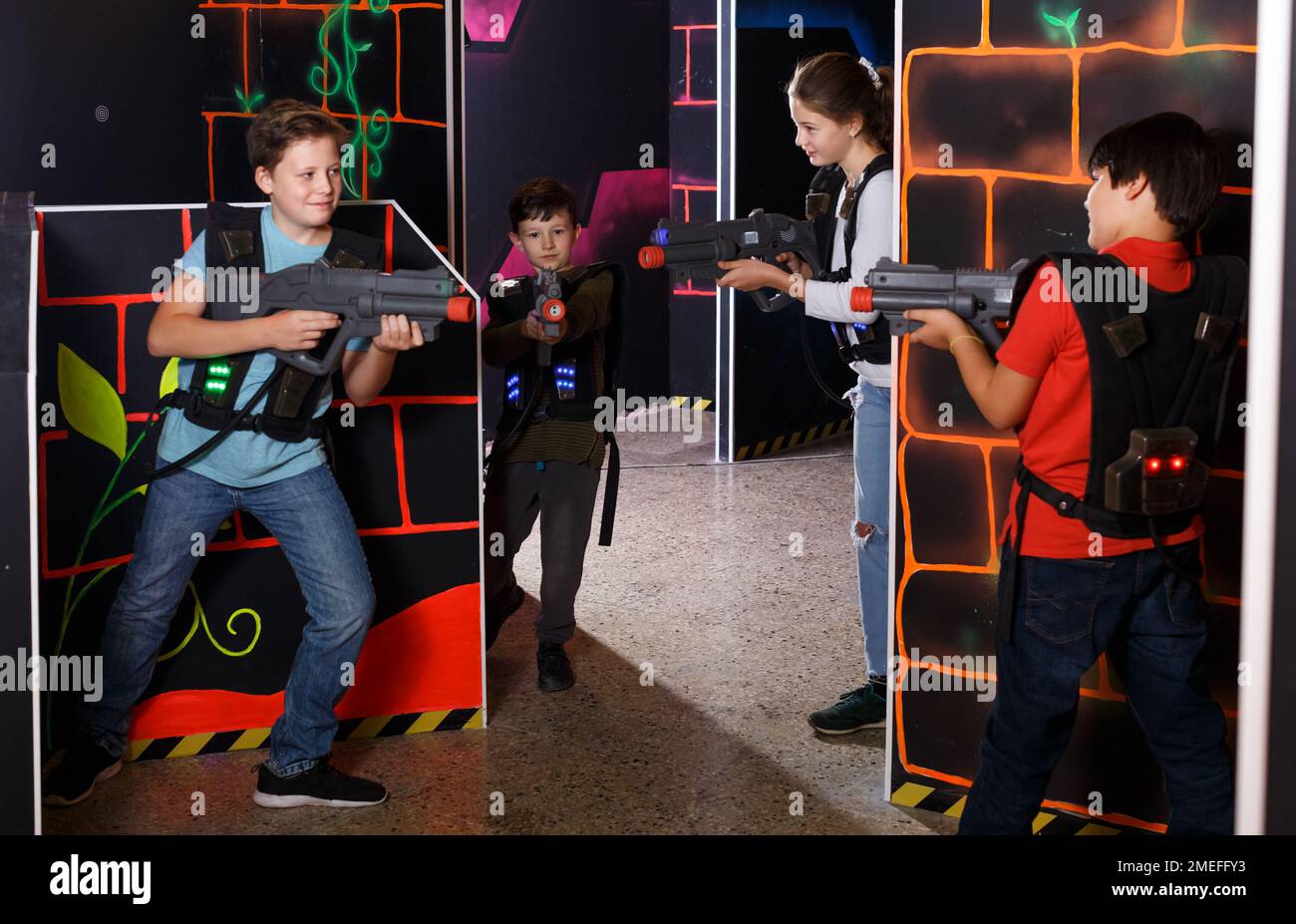 Kids playing laser tag on labyrinth Stock Photo - Alamy