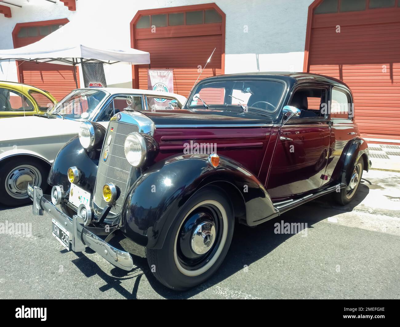 Old red burgundy and black 1953 Mercedes Benz 170 SD w136 four door sedan in the street. Expo Warnes 2022 classic car show. Stock Photo