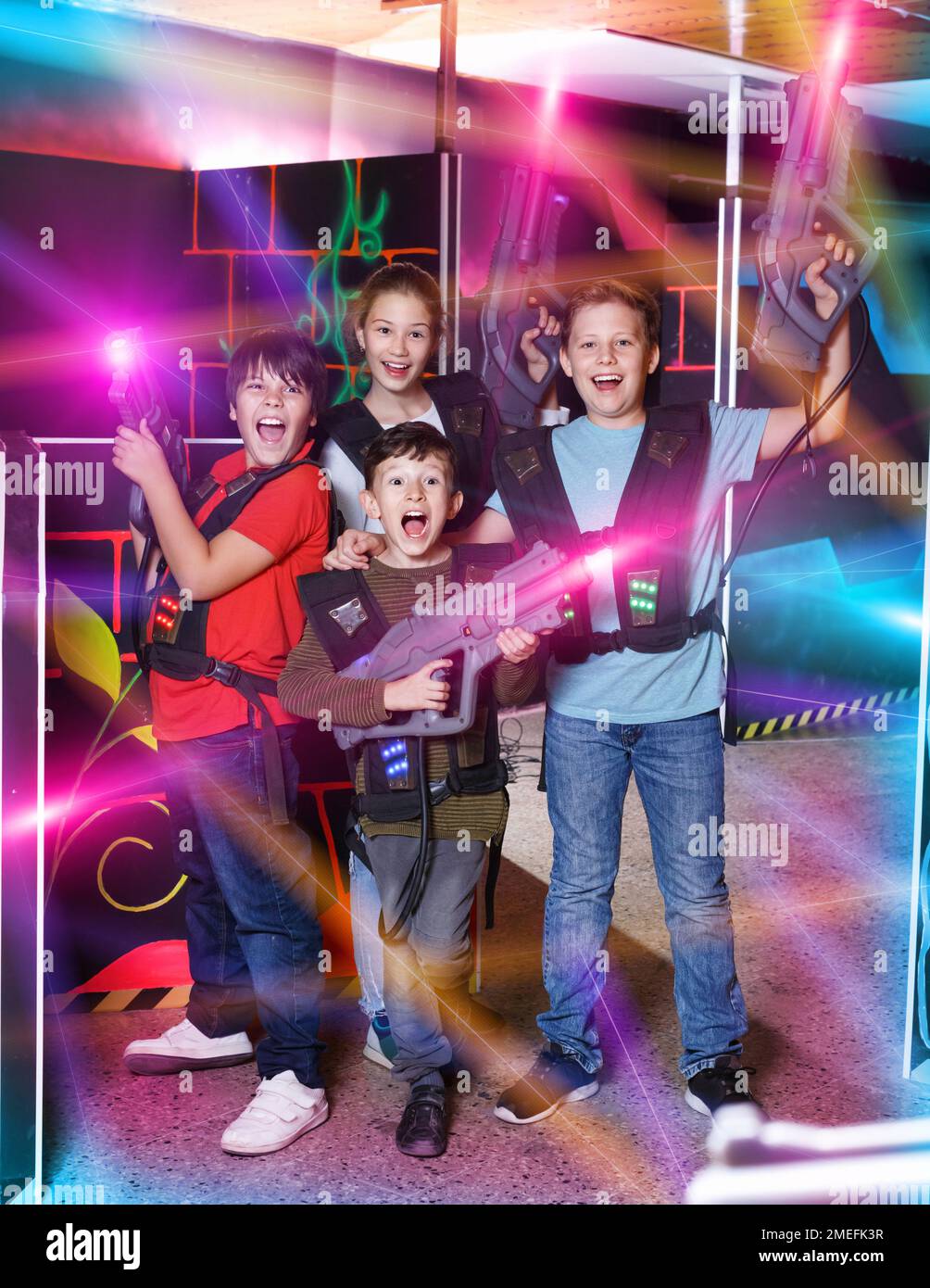 Group portrait of happy teenagers with laser guns having fun on Stock Photo Alamy