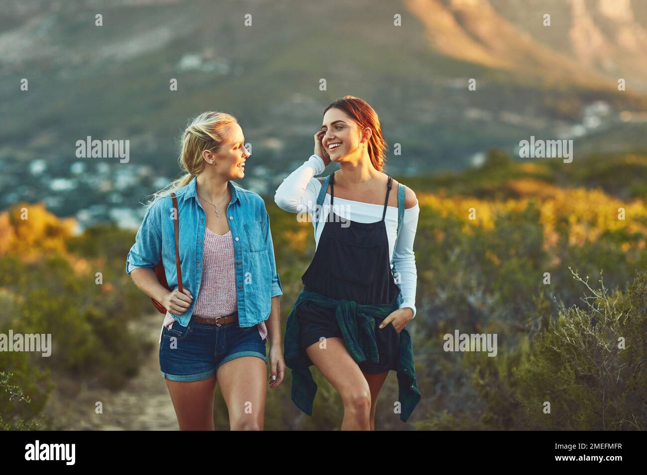 Hiking always leads to happiness. two beautiful female friends hiking ...