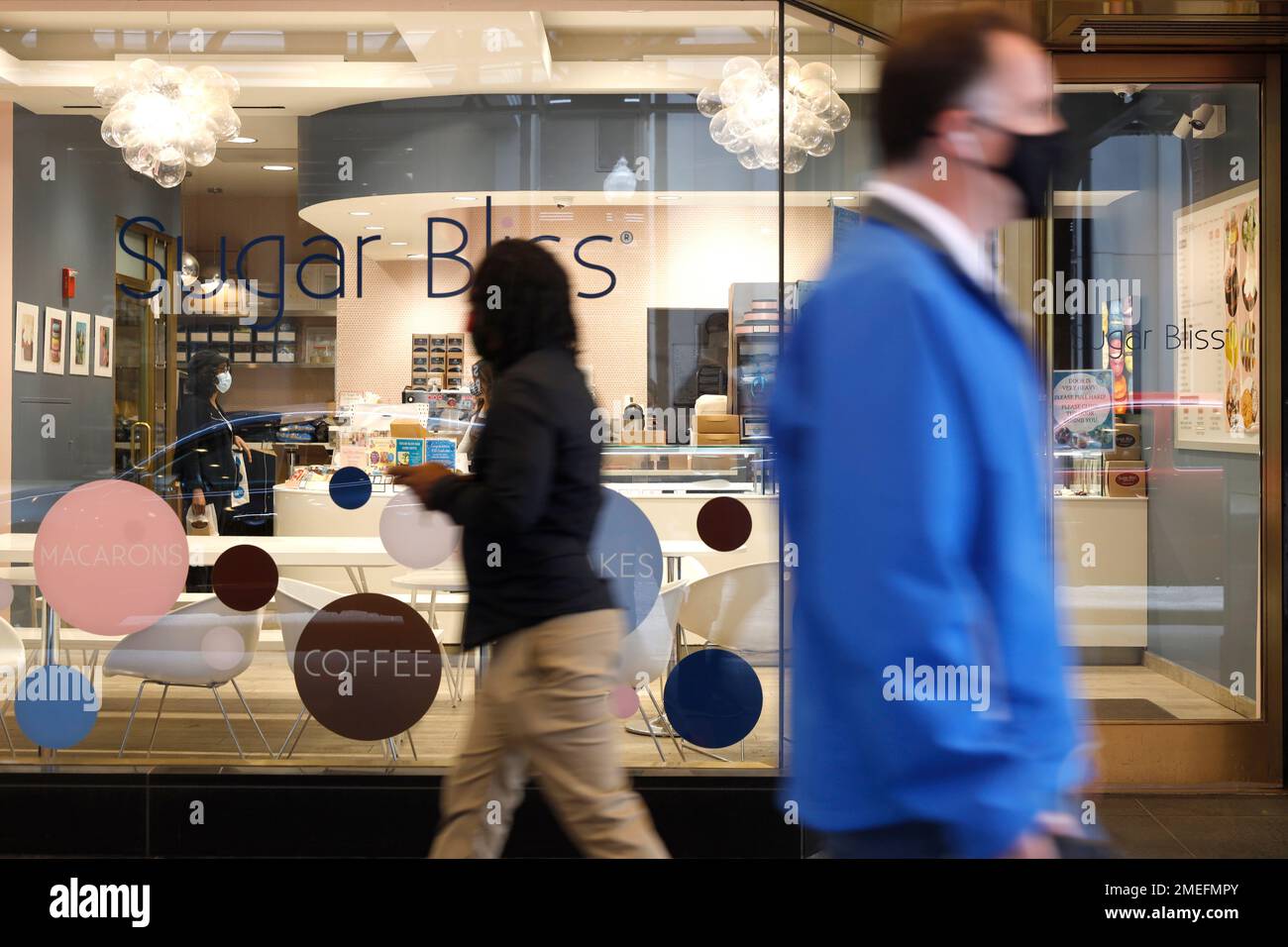 People walk past Sugar Bliss Bakery in Chicago's famed Loop on Tuesday