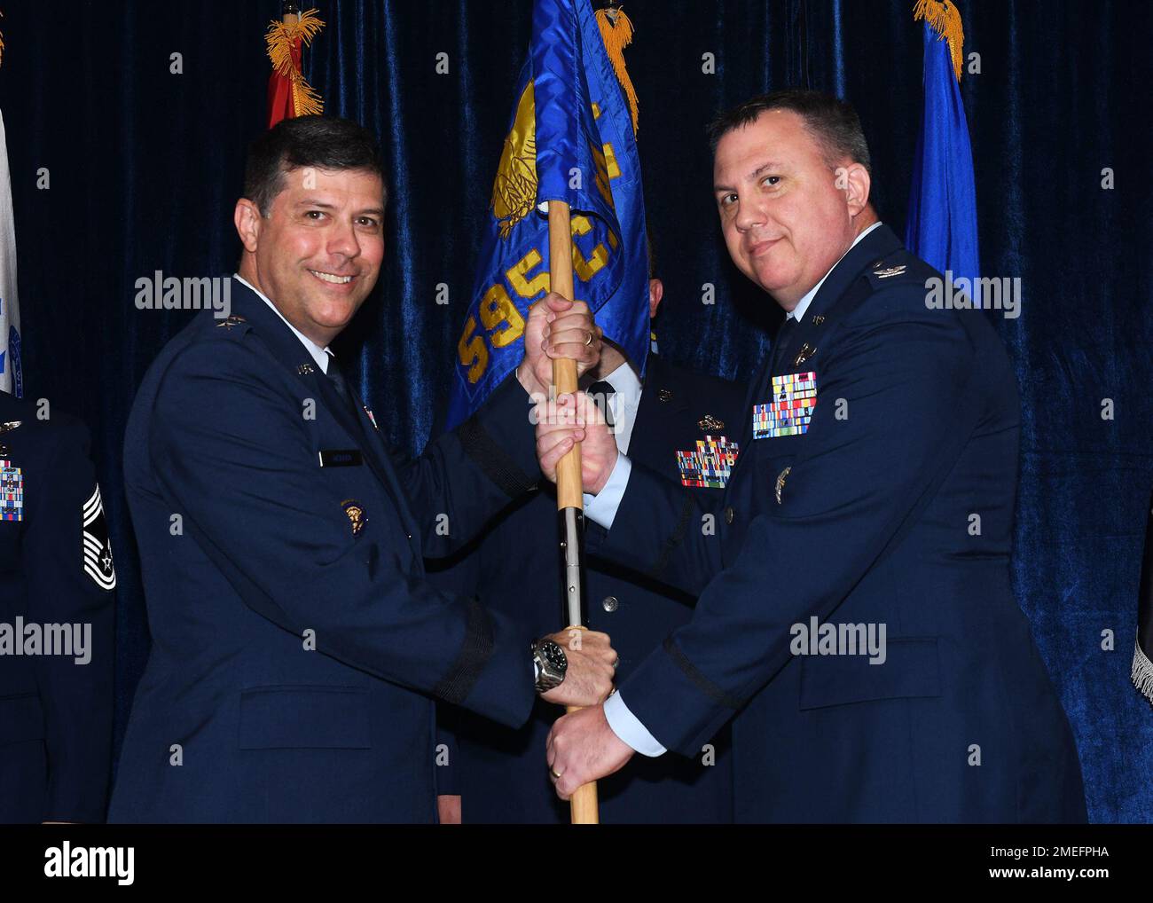 Col. David Leaumont accepts the 595th Command and Control Group guidon from Maj. Gen. Andrew J. Gebara, Eighth Air Force and Joint-Global Strike Operations Center commander, signifying him as the new commander of the unit during a ceremony at Offutt Air Force Base, Nebraska, Aug. 16, 2022. The new commander arrives to the 595th C2G and the National Airborne Operations Center from the Pentagon, where he served as the assistant deputy director for nuclear and homeland defense operations. Stock Photo