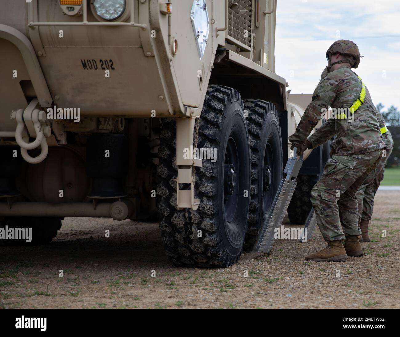 U.S. Army National Guardsmen remove scales from under a Heavy Expanded
