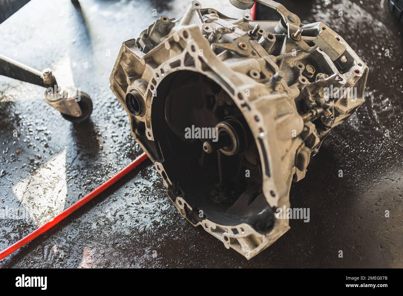 Close shot of a car gearbox with clutch removed lying on the floor