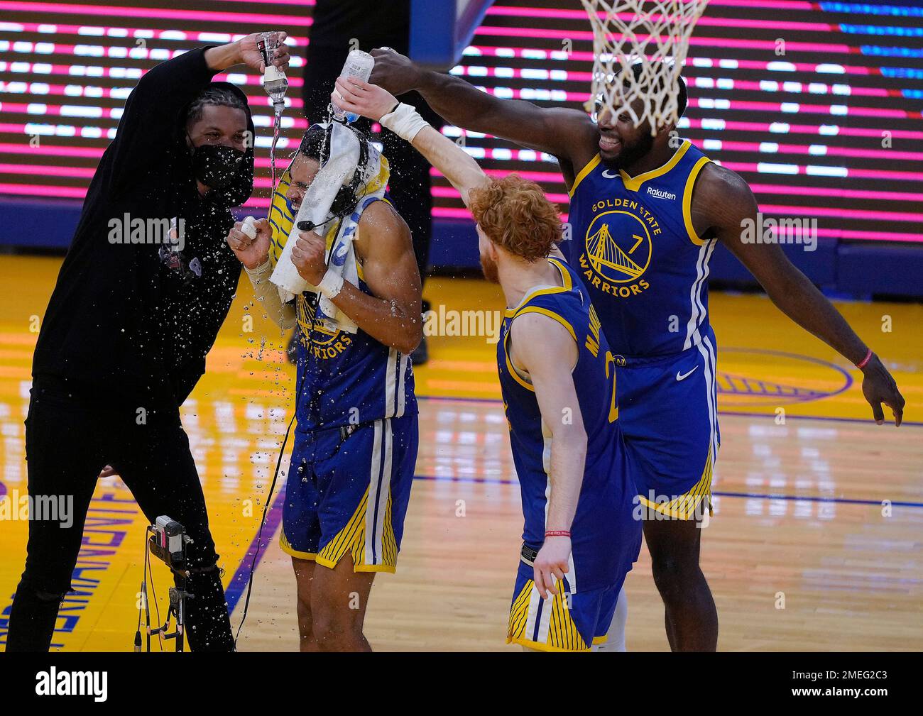 Golden State Warriors pour water over the head of guard Jordan Poole center while celebrating Poole s career high 38 points against the New Orleans Pelicans in an NBA basketball game Friday May 14