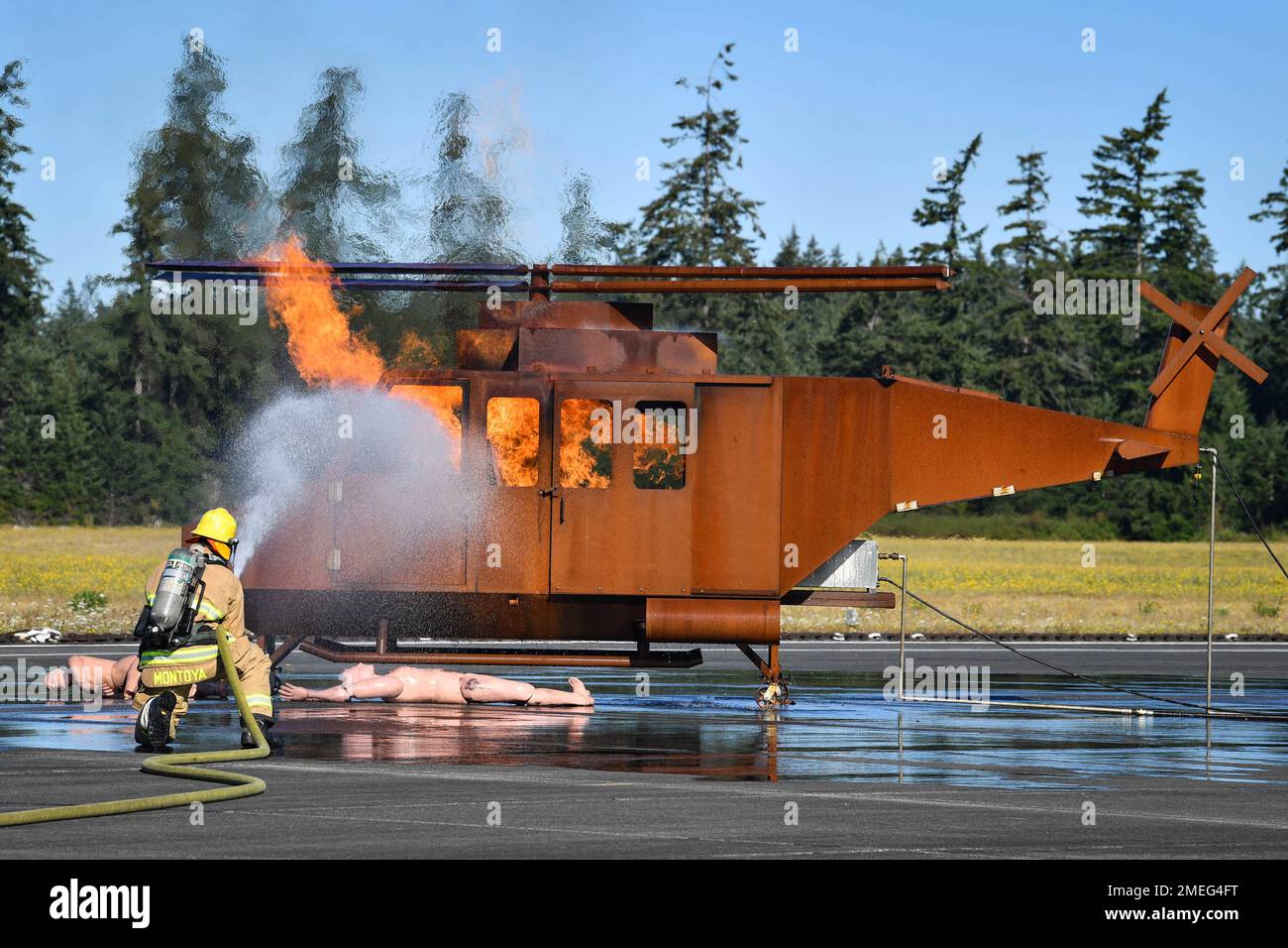 Aviation Boatswain's Mate- Aircraft Handling 2nd Class Dakota Montoya puts out a fire during an aircraft mishap drill on the Naval Outlying Field in Coupeville, Washington August 17, 2022. The joint training tested the aircraft mishap response procedures of our Federal Fire, Search and Rescue, and local first responders. Stock Photo