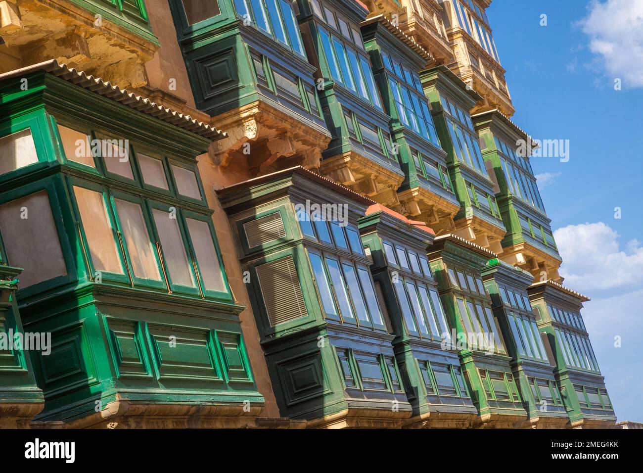 Valletta, Malta - Typical Maltese green balconies on ancient house at Valletta with blue sky and clouds Stock Photo