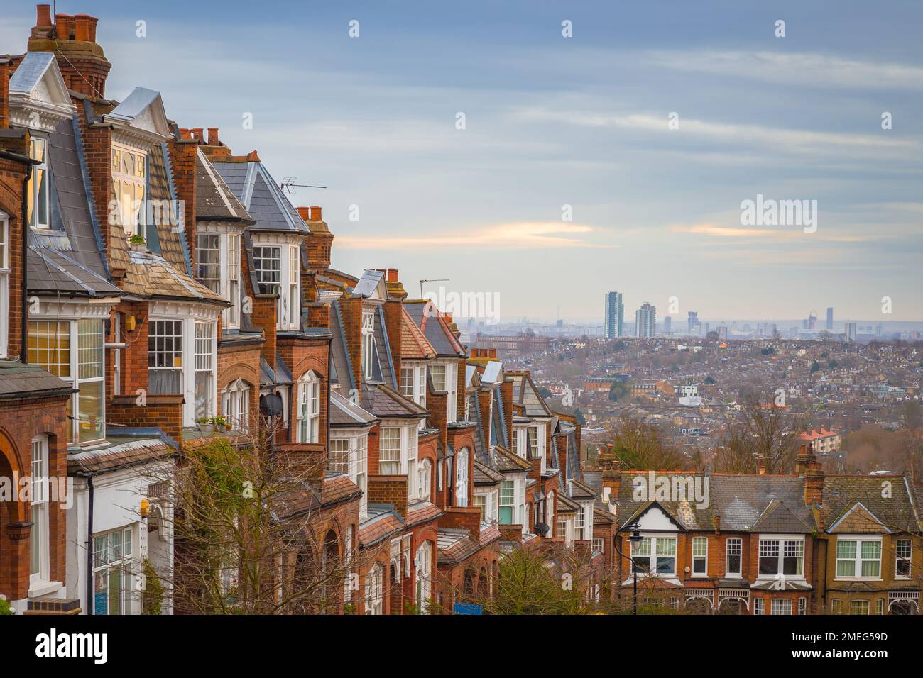 London, United Kingdom - Traditional British brick houses on a cloudy morning with east London at background. Panoramic shot from Muswell Hill Stock Photo