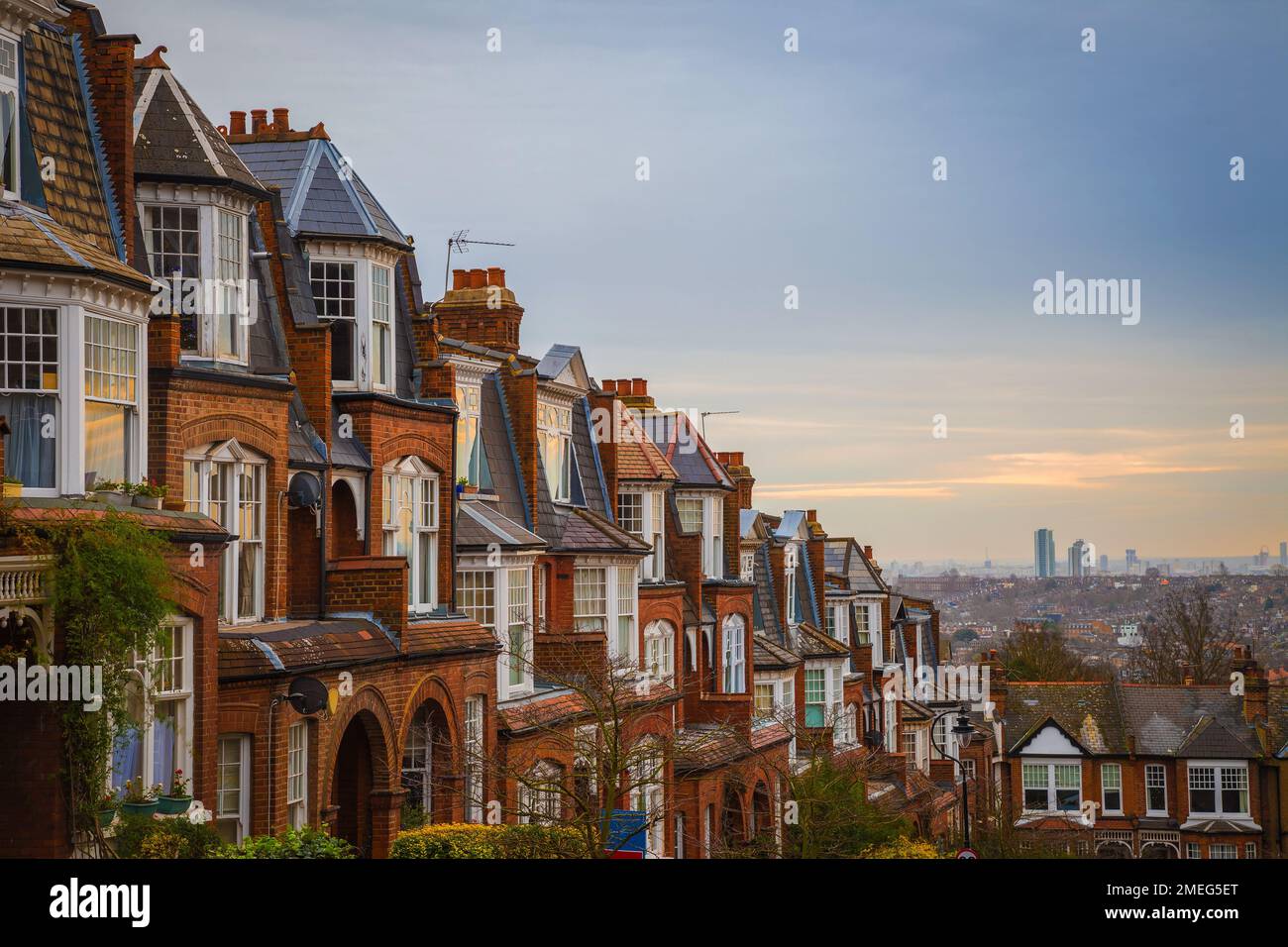 London, United Kingdom - Traditional British brick houses on a cloudy morning with east London at background. Panoramic shot from Muswell Hill Stock Photo