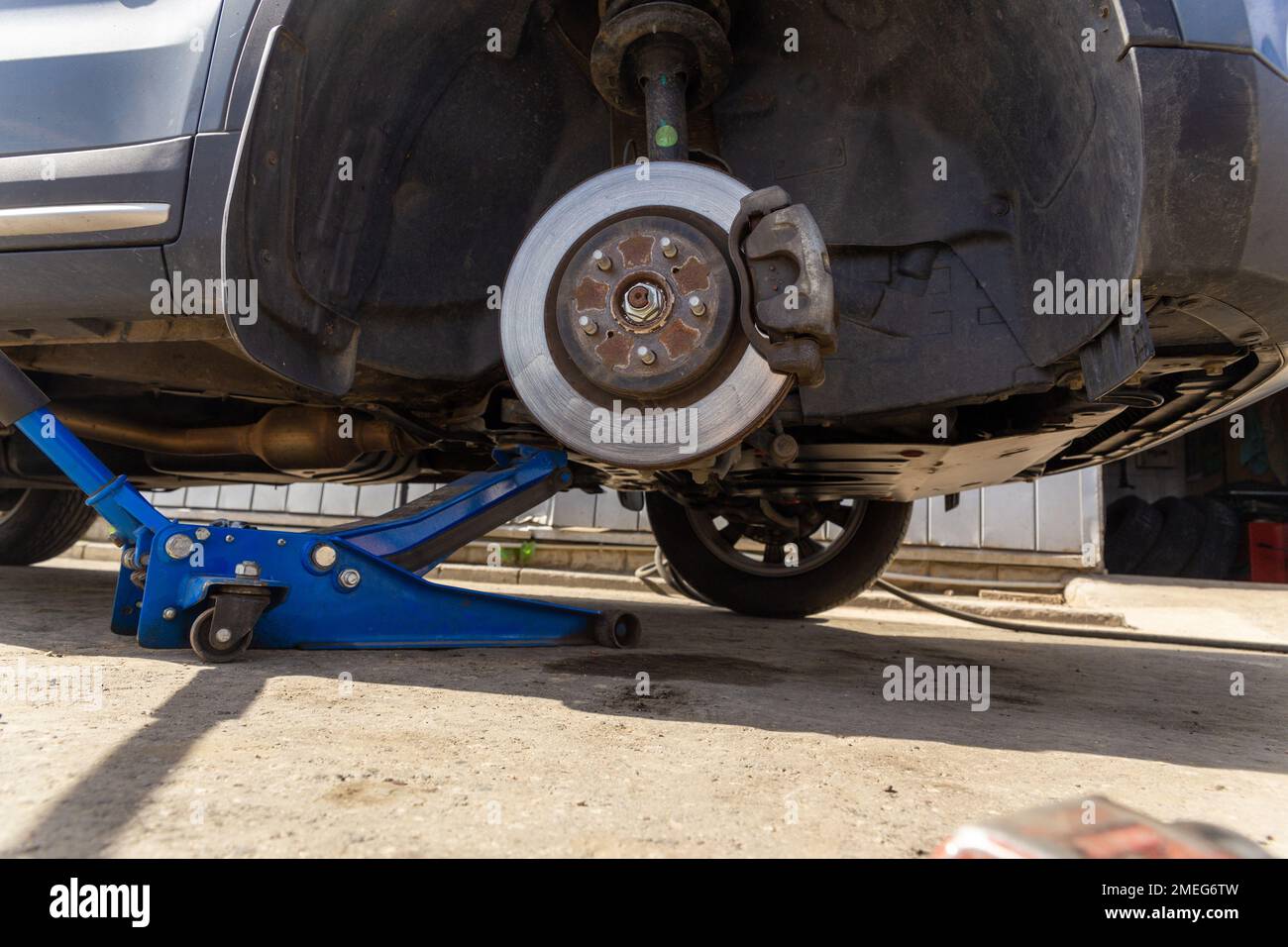 Hydraulic car jack lift the new car for change the tyre. Seasonal tyre