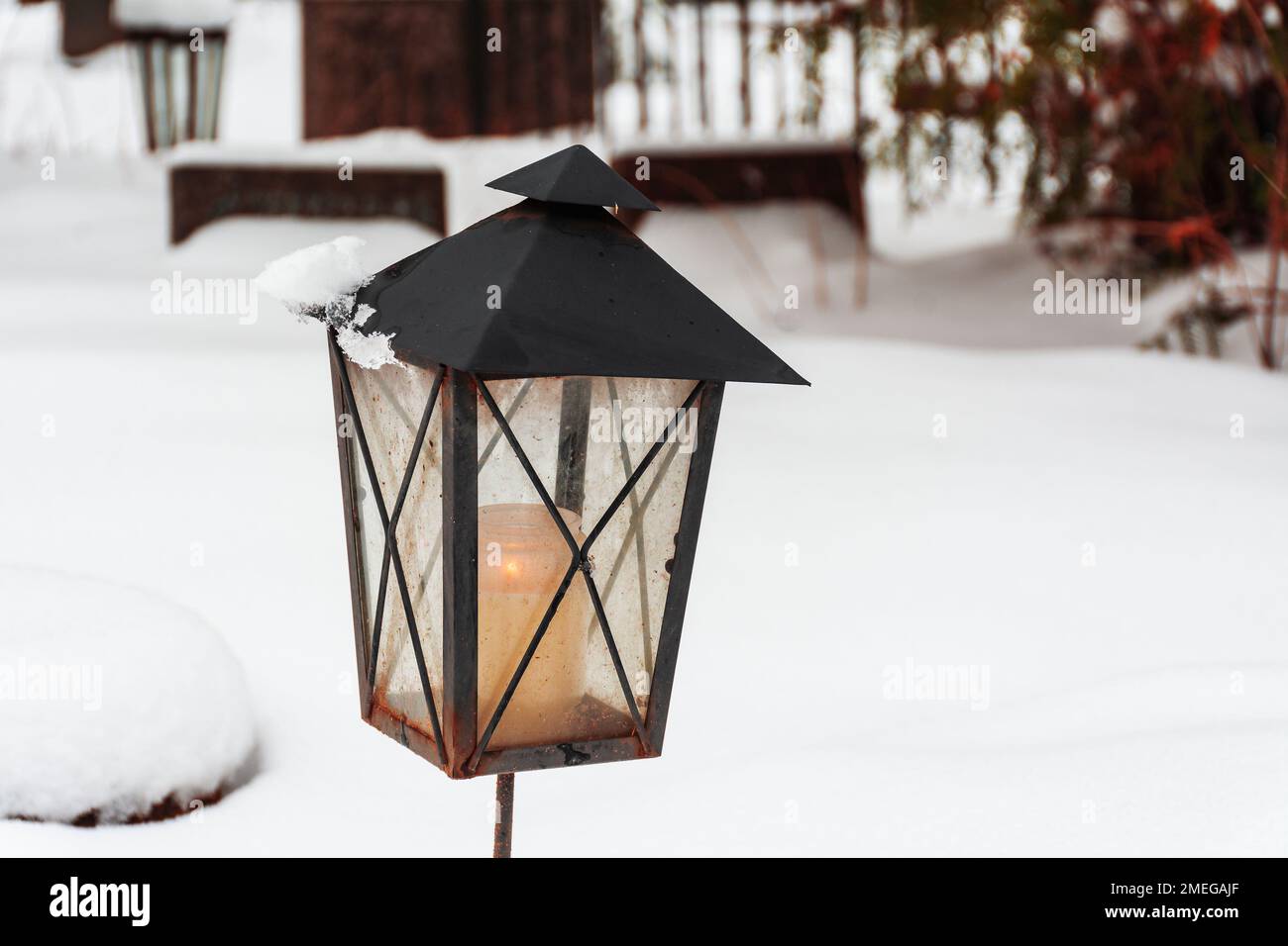 Metal lantern at snowy Toome kalmistu graveyard in Viljandi Estonia Stock Photo