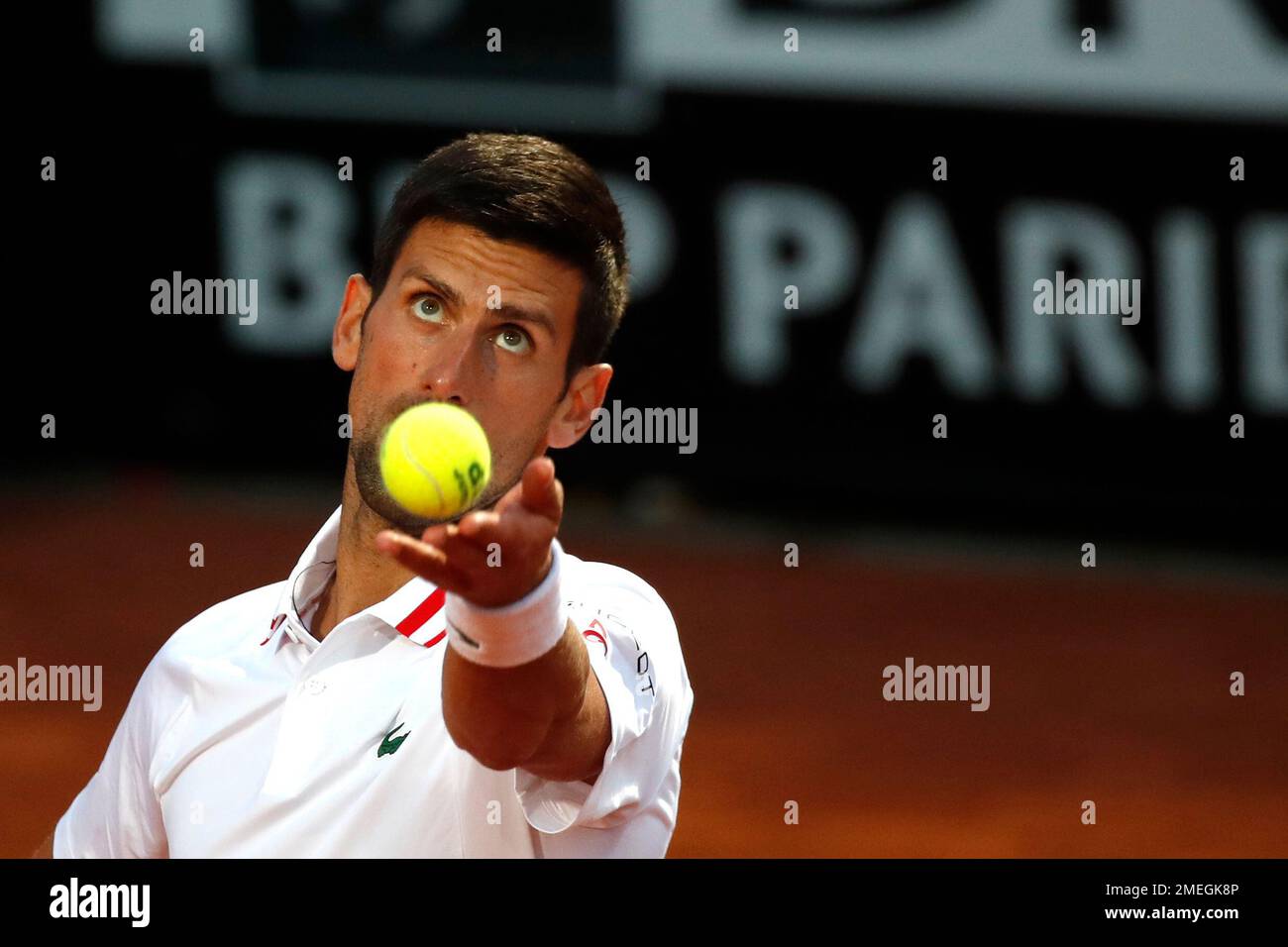Novak Djokovic of Serbia serves the ball to Taylor Fritz of the United States during their match at the Italian Open tennis tournament, in Rome, Tuesday, May 11, 2021