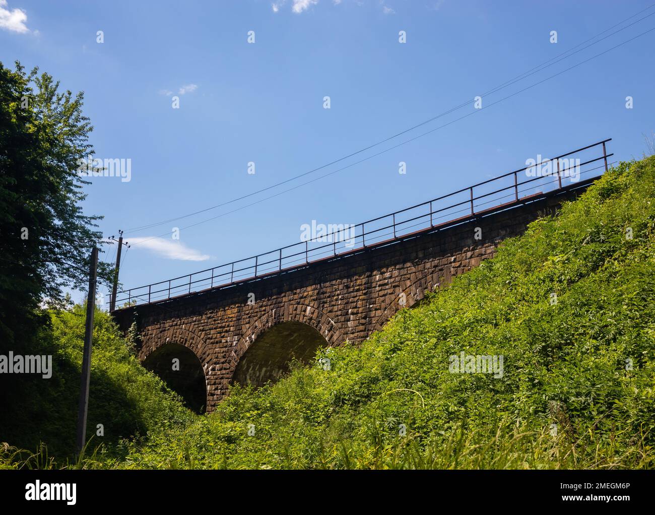 the old railway bridge is built of stone. historic building used Stock Photo