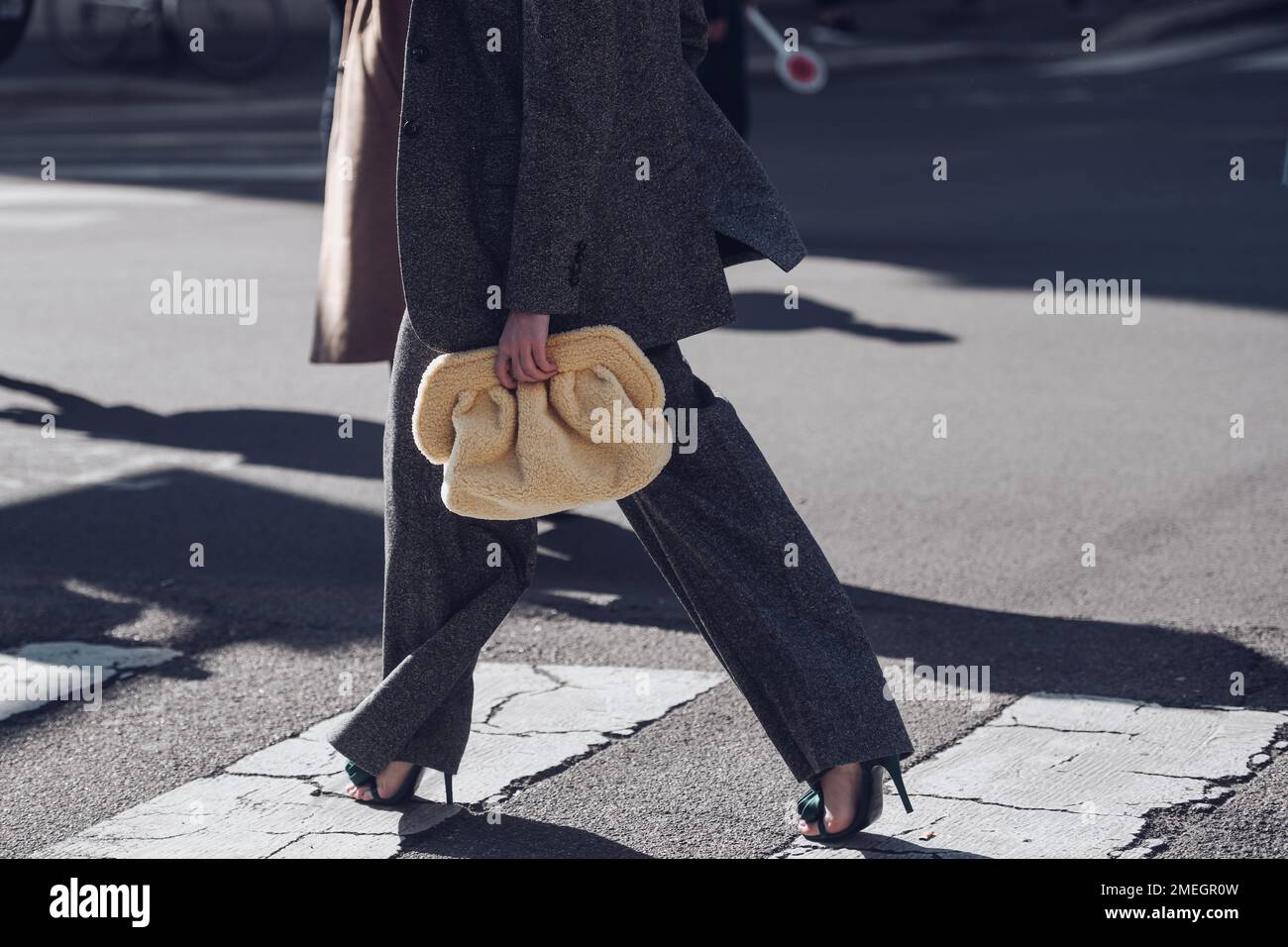 Milan, Italy - February 25, 2022: Woman in trendy wool suit with palazzo pants and high heels. Stock Photo