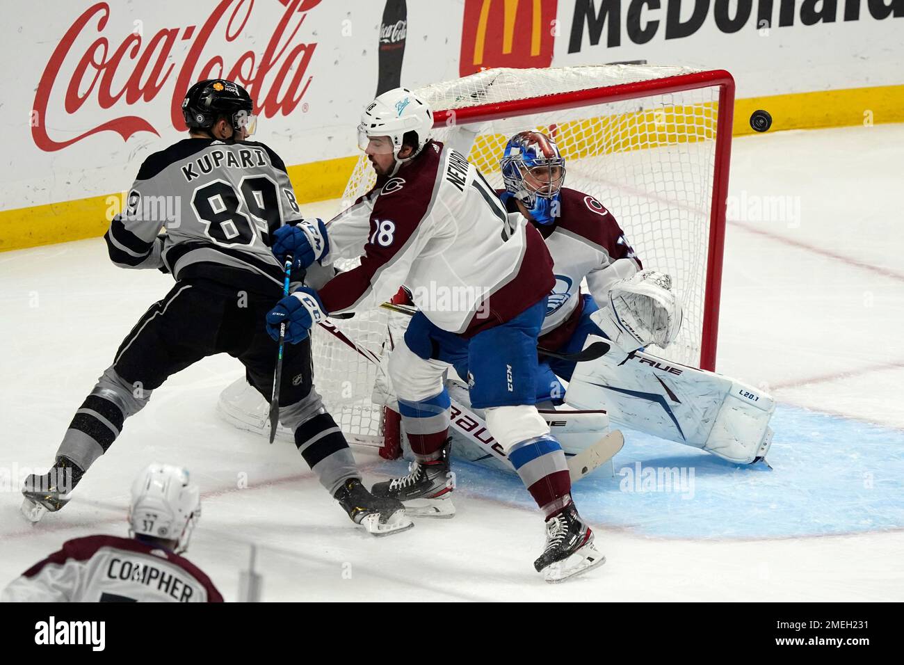 Colorado Avalanche goaltender Jonas Johansson, right, deflects a shot