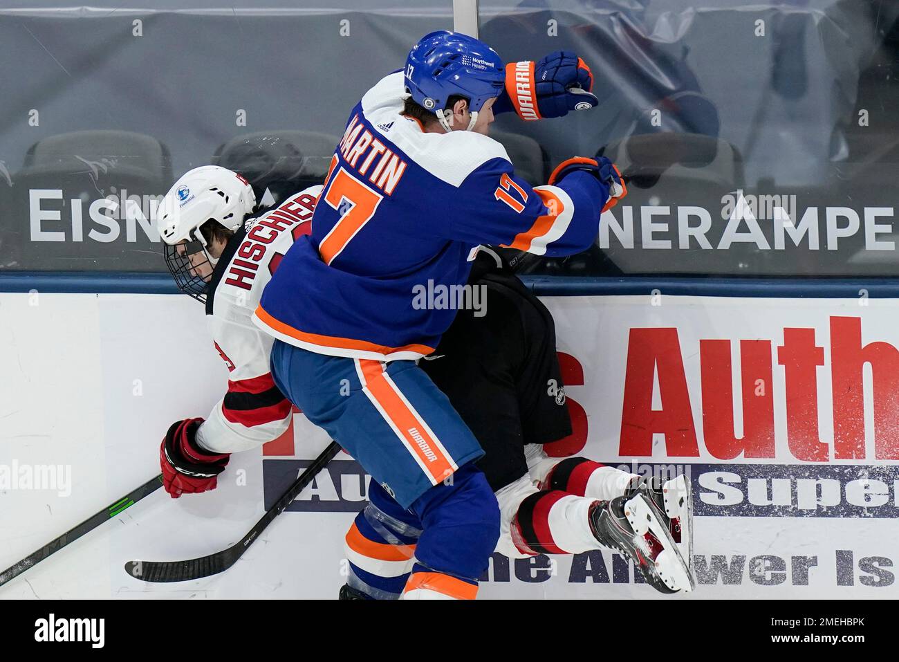 New York Islanders' Matt Martin (17) checks New Jersey Devils' Nico  Hischier during the second period of an NHL hockey game Thursday, May 6,  2021, in Uniondale, N.Y. (AP Photo/Frank Franklin II