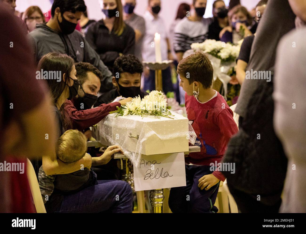https://c8.alamy.com/comp/2MEHJ51/relatives-pay-their-final-respects-to-1-year-old-ana-bella-fernandes-who-was-killed-by-a-knife-wielding-attacker-inside-a-day-care-center-during-a-wake-at-a-city-park-in-saudades-in-the-southern-state-of-santa-catarina-brazil-wednesday-may-5-2021-the-citys-mayor-said-that-a-youth-aged-between-14-and-18-years-old-had-entered-the-day-care-center-tuesday-with-a-knife-killing-three-children-a-teacher-and-a-teachers-assistant-ap-photoliamara-polli-2MEHJ51.jpg