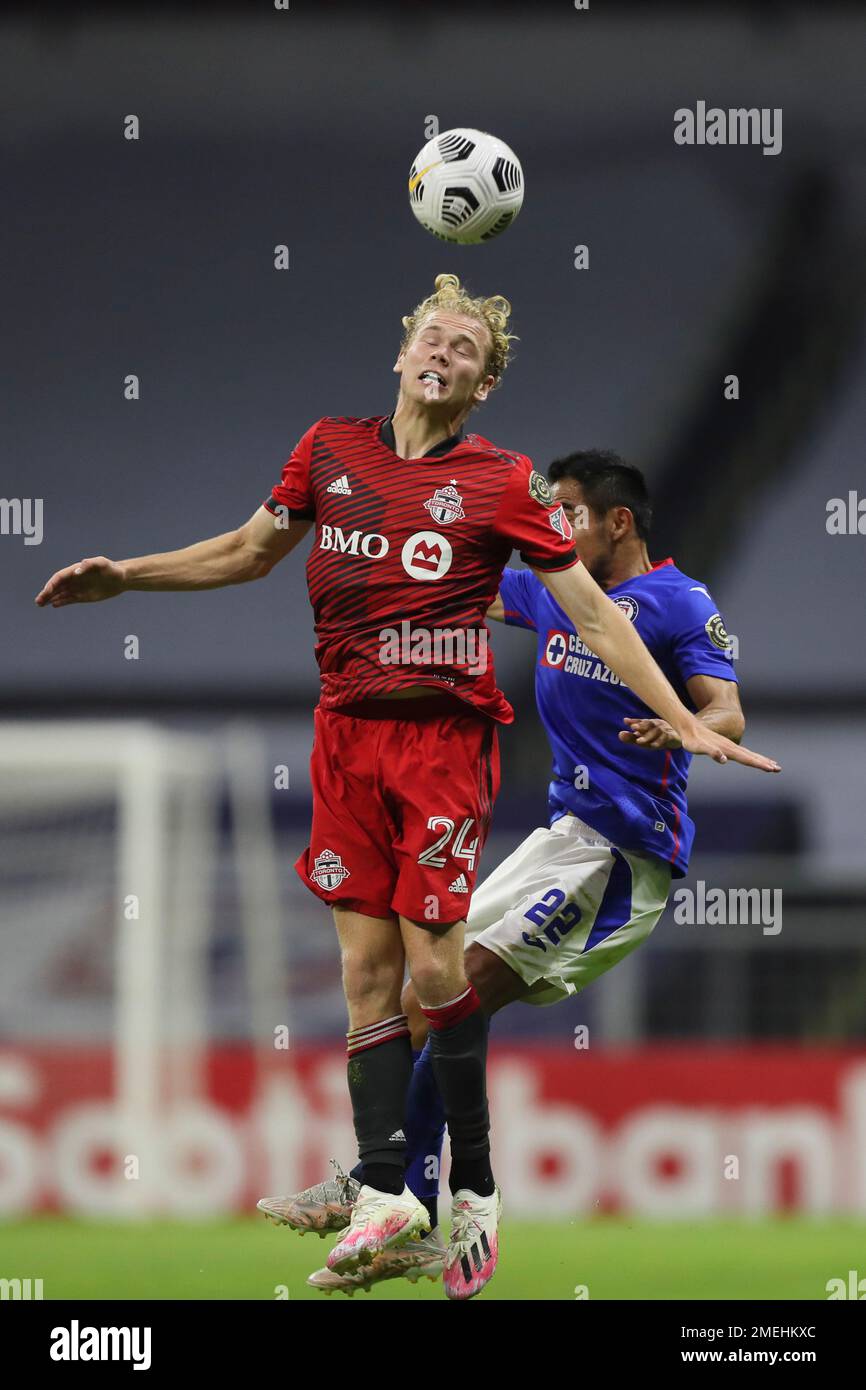 Jacob Shaffelburg of Canada's Toronto FC (24) heads the ball challenged by  Rafael Baca of Mexico's Cruz Azul during a CONCACAF Champions League  quarterfinal second leg soccer match at Azteca stadium in