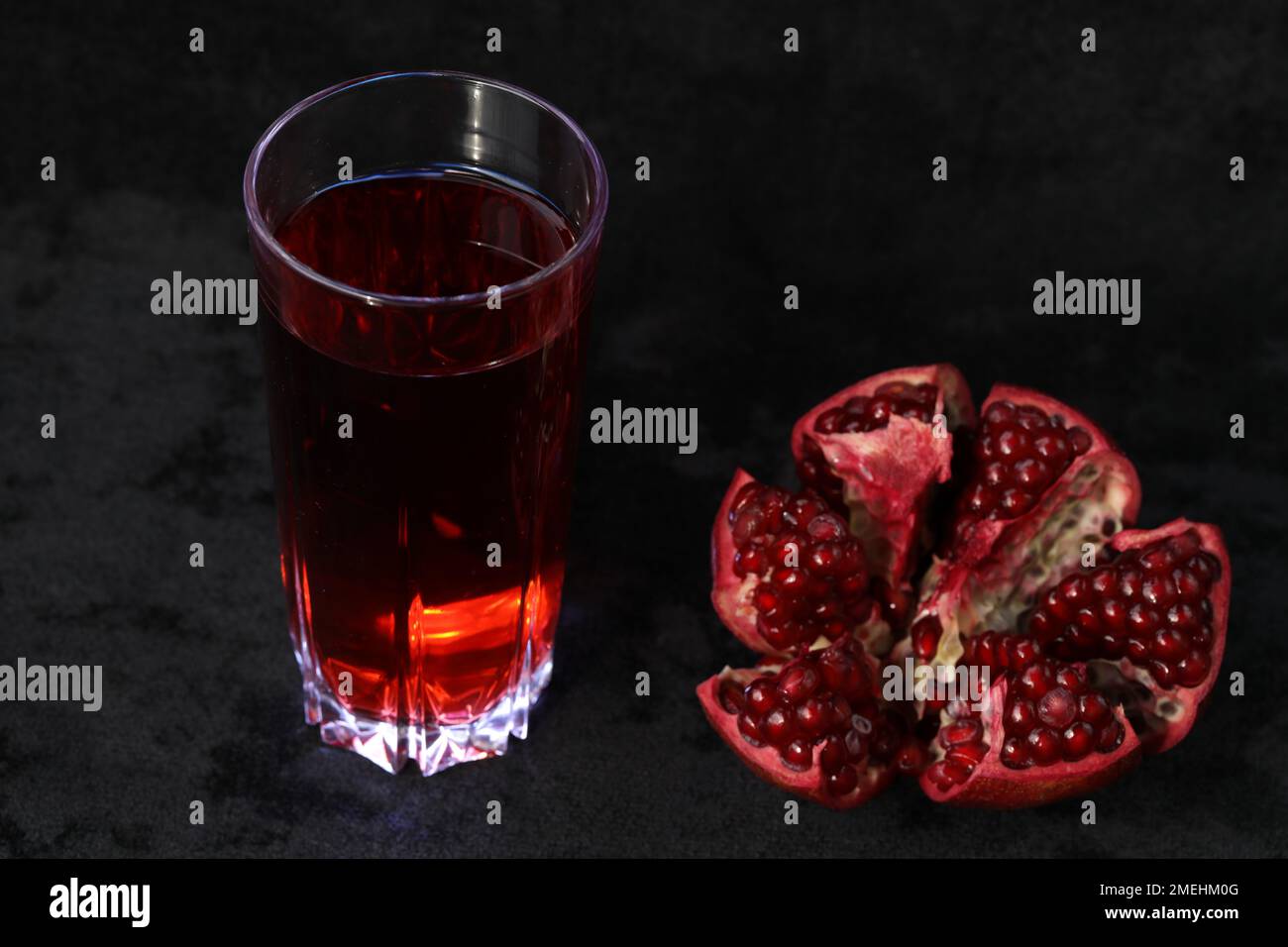 pomegranate juice in a glass and pomegranate Stock Photo Alamy