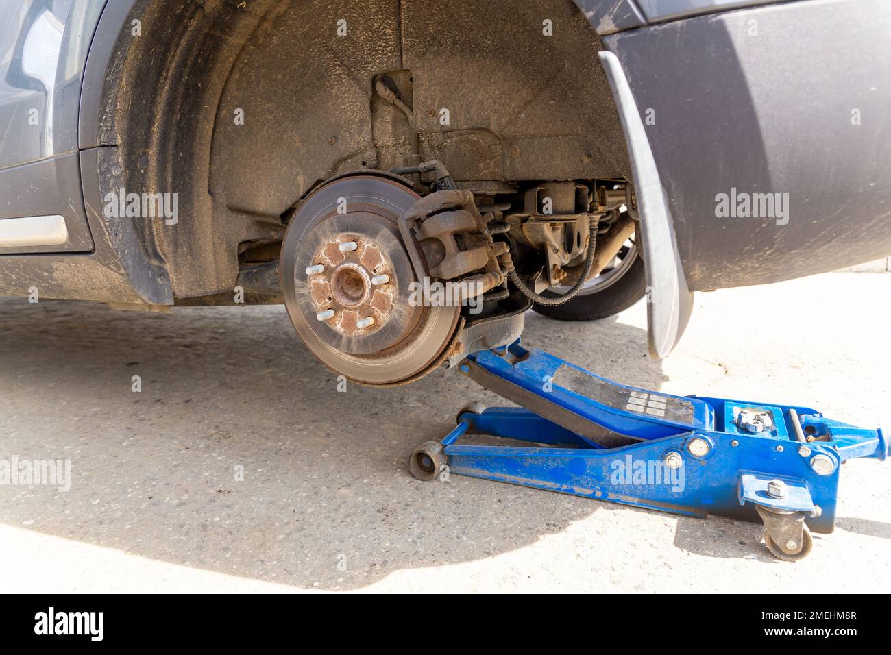 Hydraulic car jack lift the new car for change the tyre. Seasonal tyre