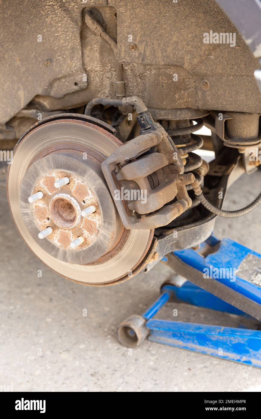 Hydraulic car jack lift the new car for change the tyre. Seasonal tyre