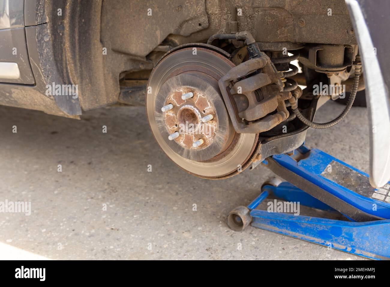 Hydraulic car jack lift the new car for change the tyre. Seasonal tyre