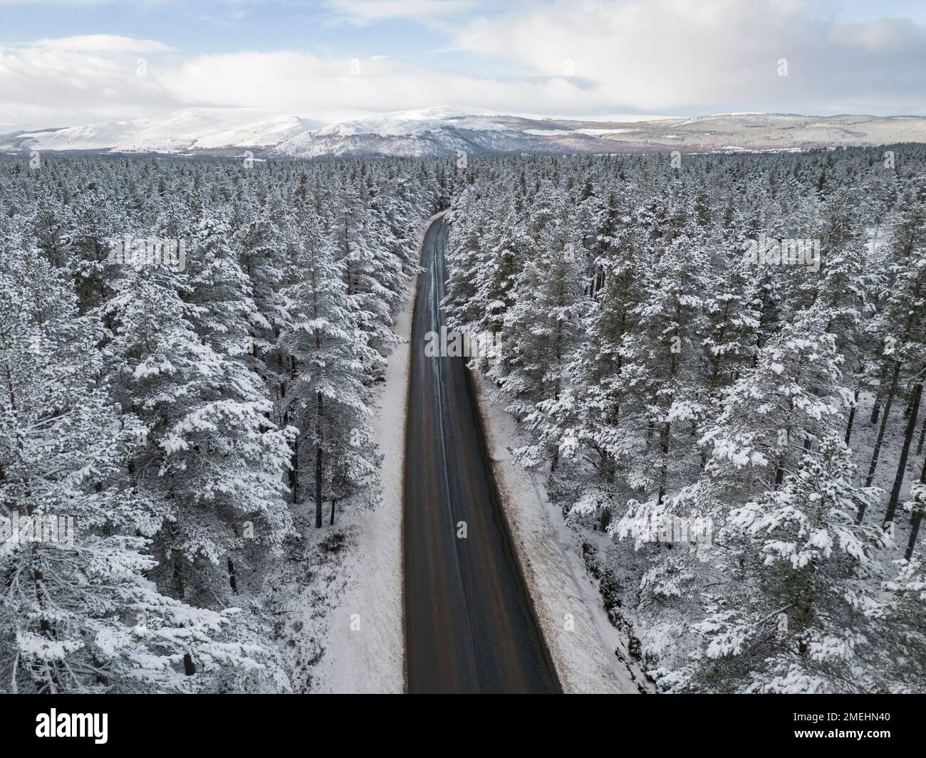 Aerial view of road in snow Rothiemurchus forest  in Cairngorms national Park, Scottish Highlands, Scotland, UK Stock Photo