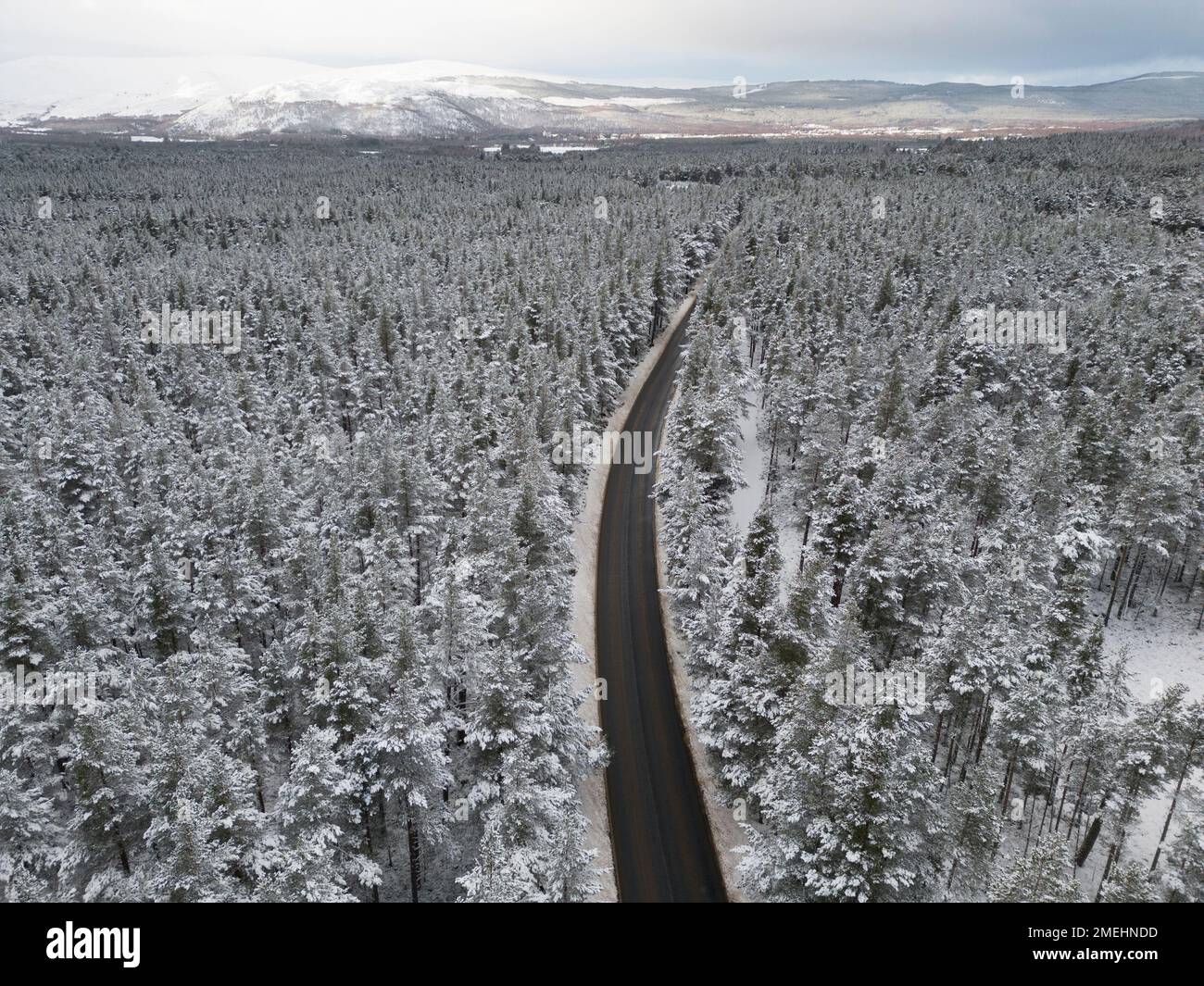 Aerial view of road in snow Rothiemurchus forest  in Cairngorms national Park, Scottish Highlands, Scotland, UK Stock Photo