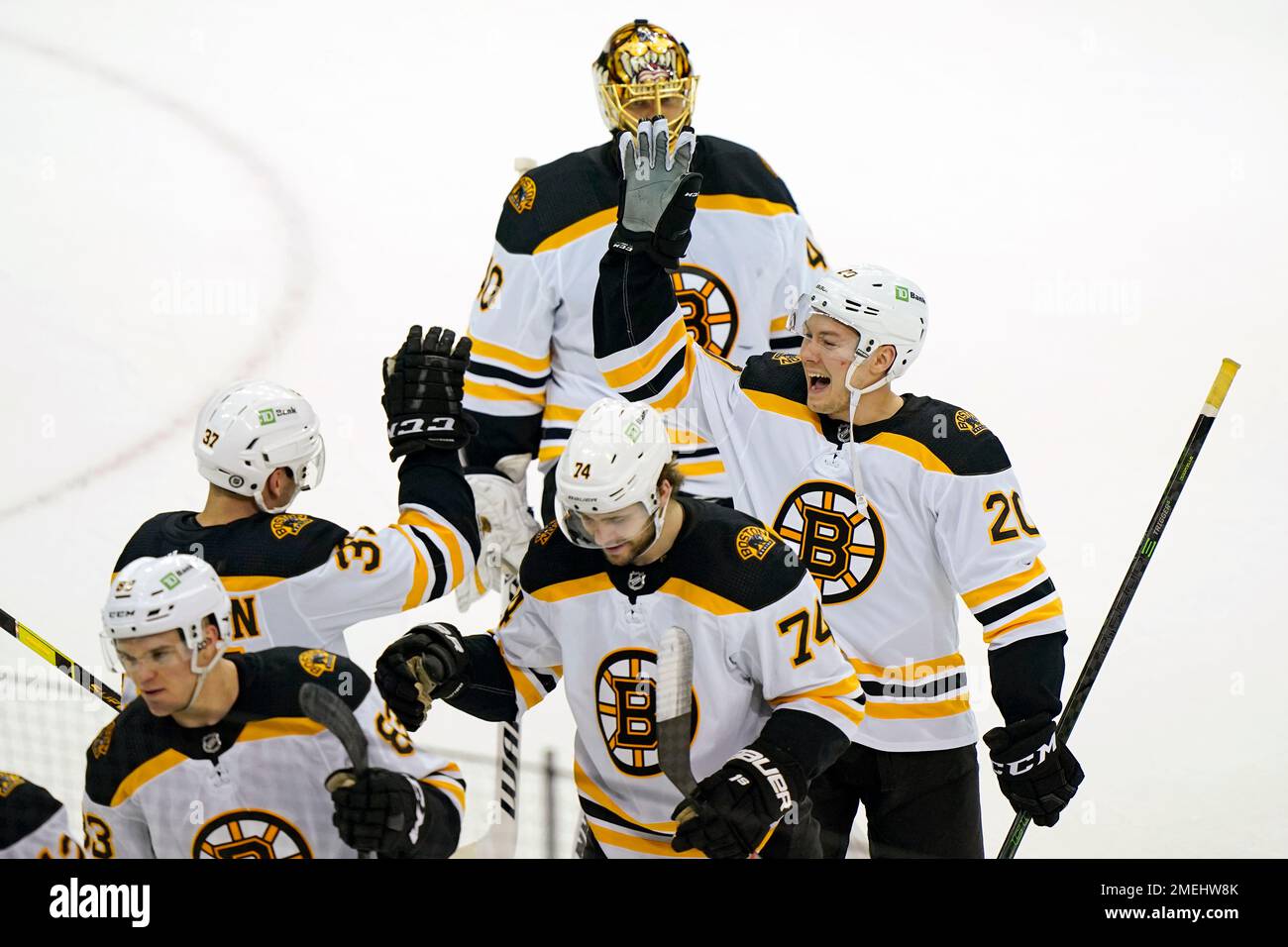 Boston Bruins center Curtis Lazar (20) celebrates with Bruins center  Patrice Bergeron (37) after an NHL