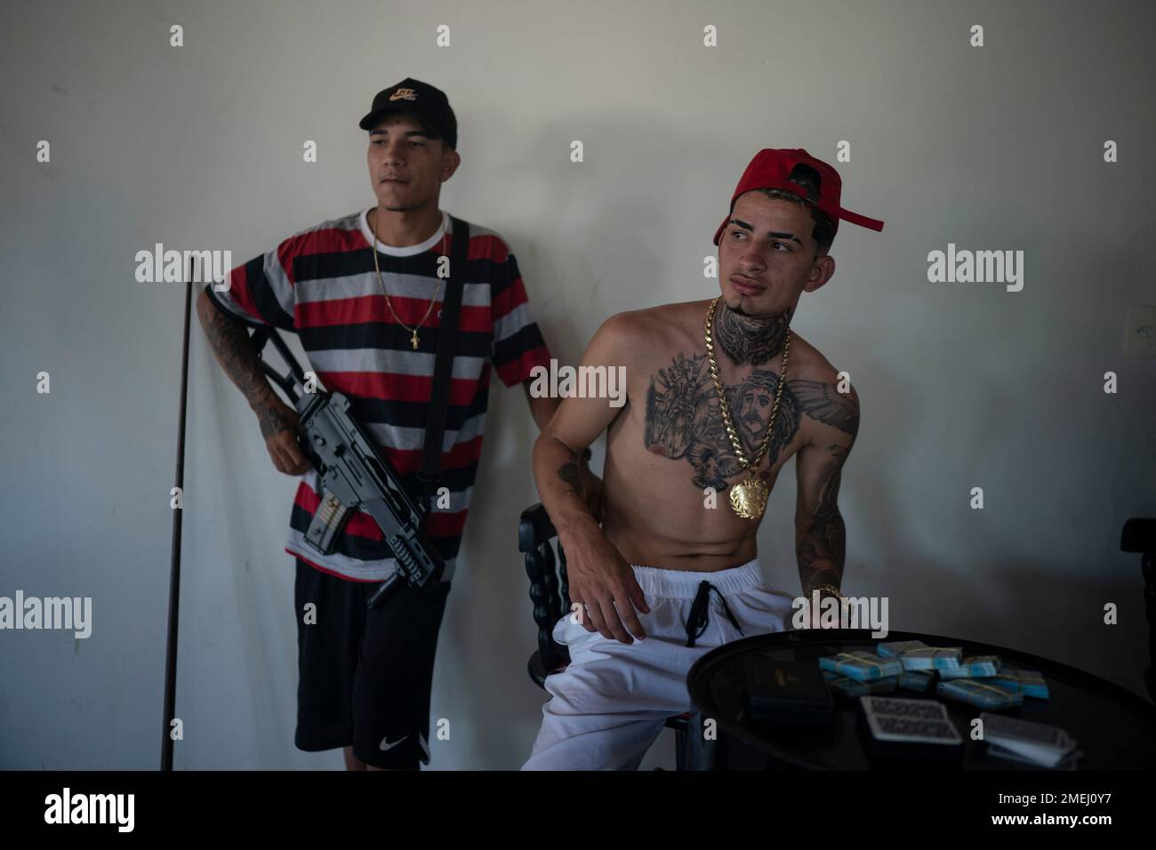 Trap artist Denilson, known as TB holds an Airsoft gun a he