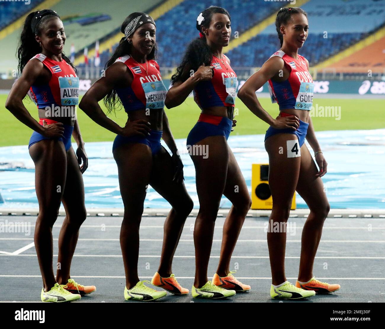 Members of the Cuban relay team celebrate after competing in the women