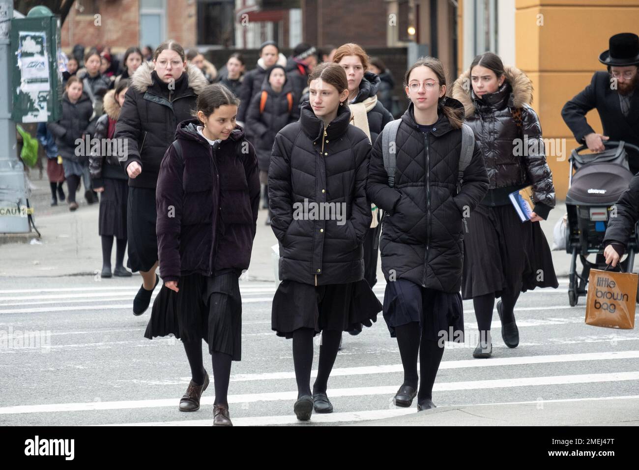 A street scene featuring ultra orthodox Jewish girls heading home from school.  All were dressed modestly in long black skirts. In Brooklyn, New York. Stock Photo